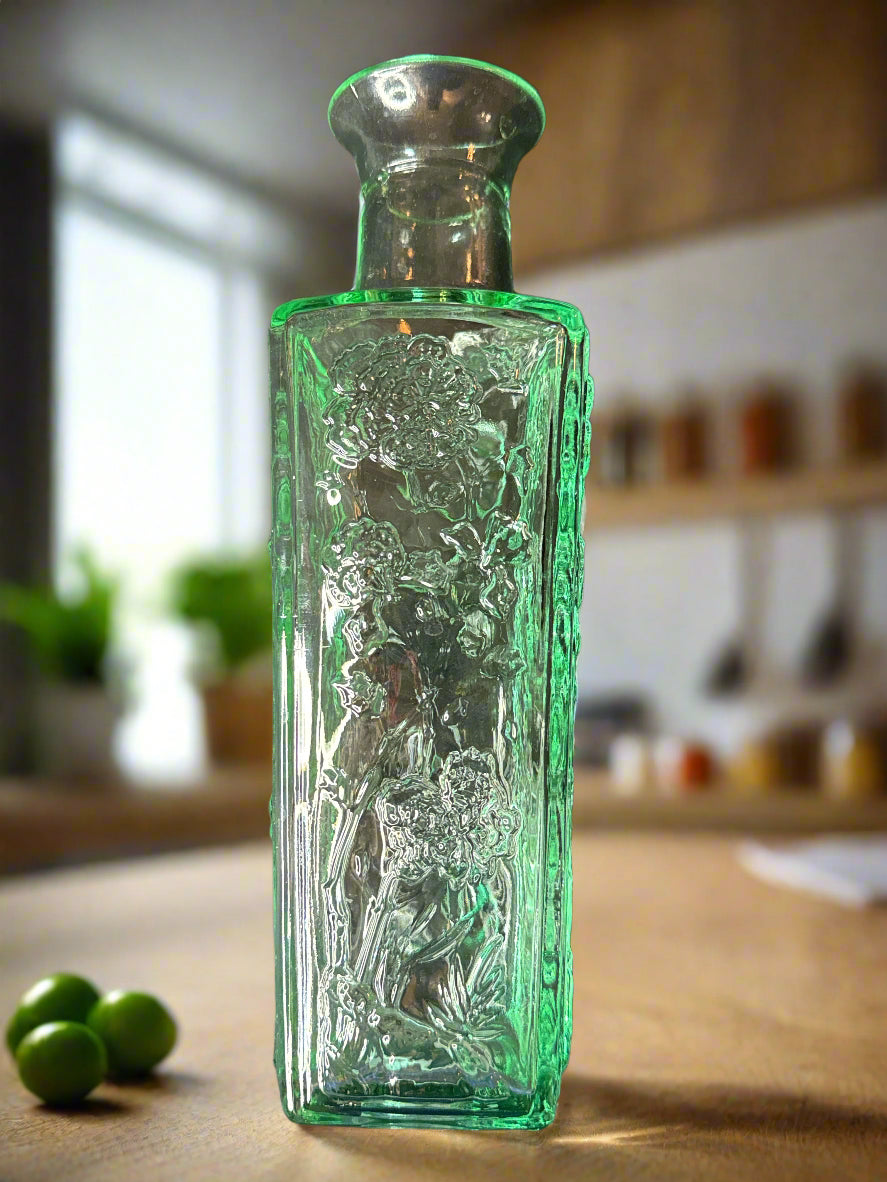 10" Tall Glass Bottle Raised Floral Design Aqua Excellent condition.