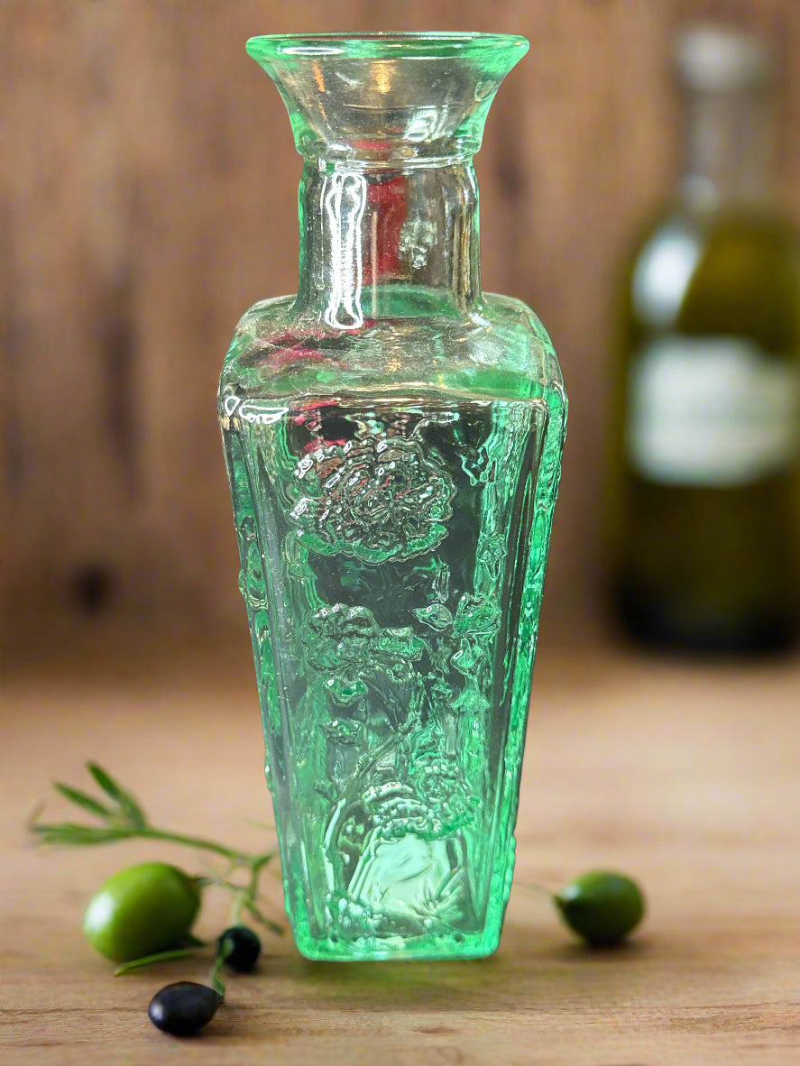 10" Tall Glass Bottle Raised Floral Design Aqua Excellent condition.