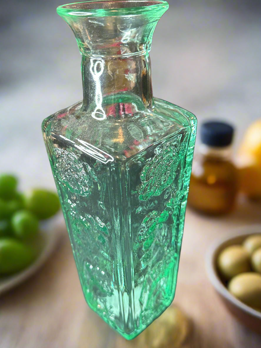 10" Tall Glass Bottle Raised Floral Design Aqua Excellent condition.