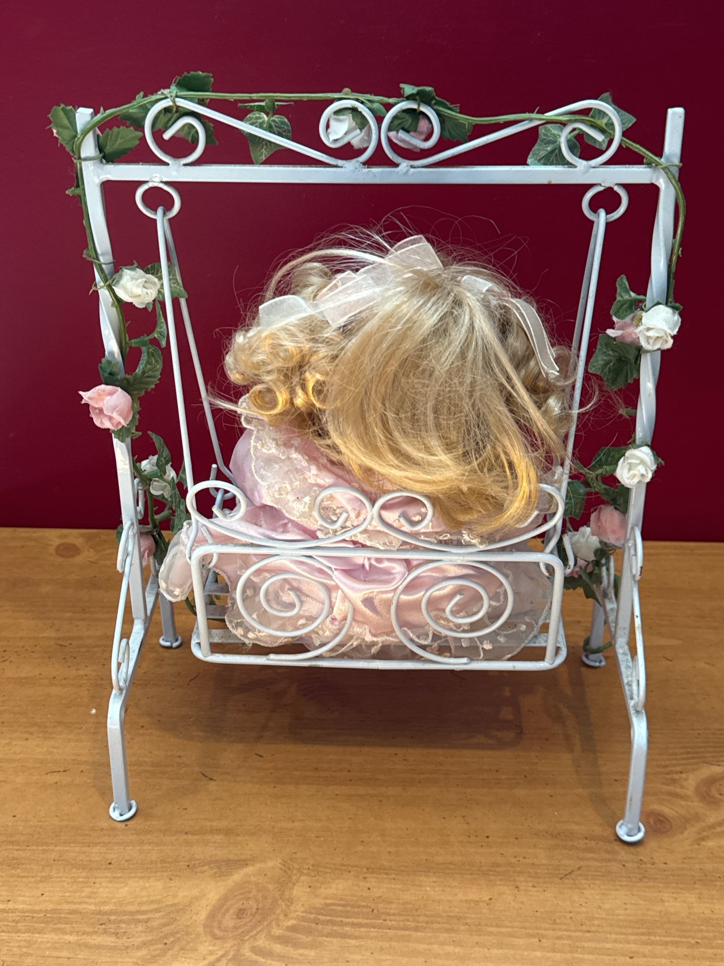 Vintage Porcelain Doll in Purple Dress on Floral Metal Swing