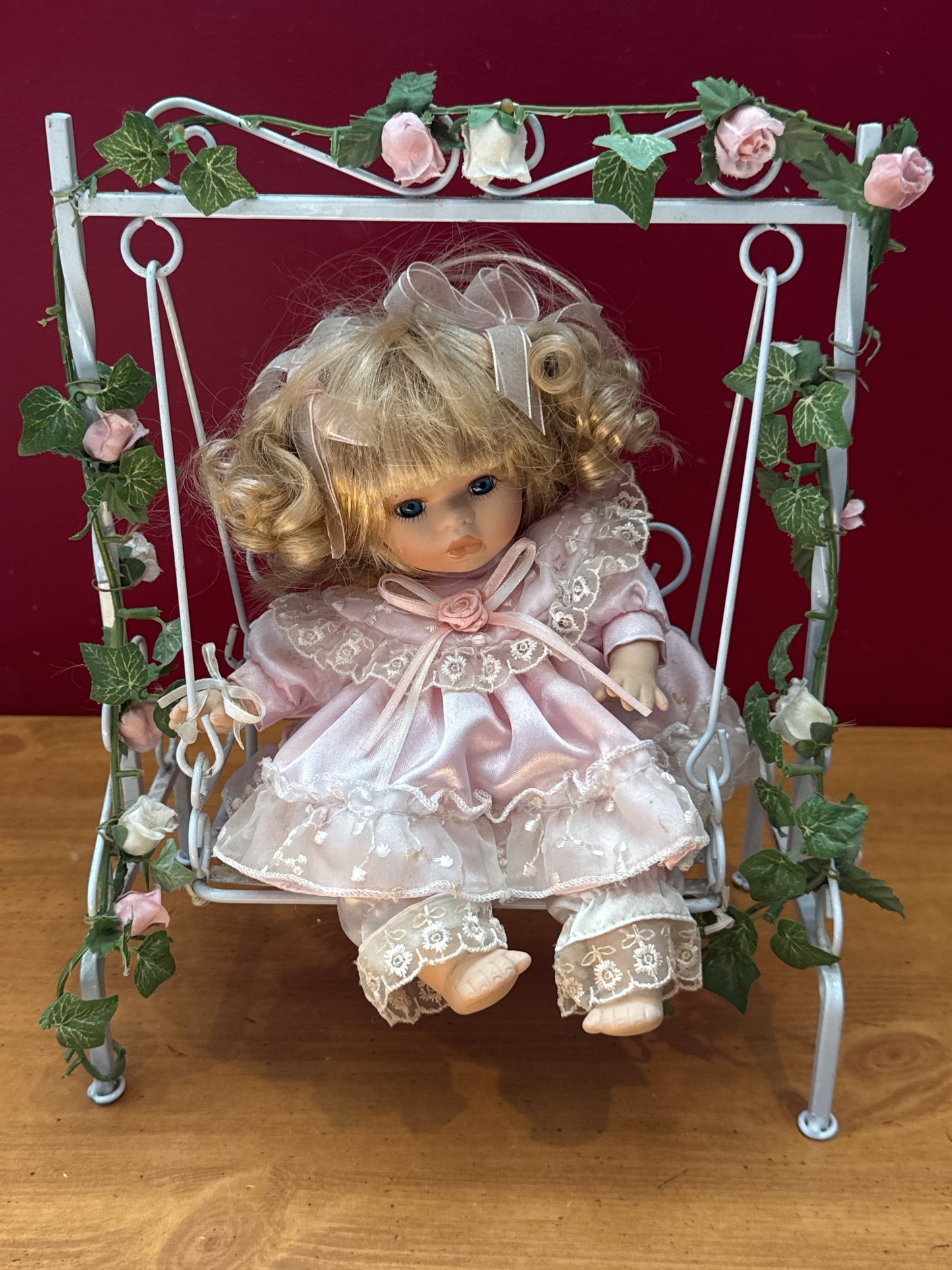 Vintage Porcelain Doll in Purple Dress on Floral Metal Swing
