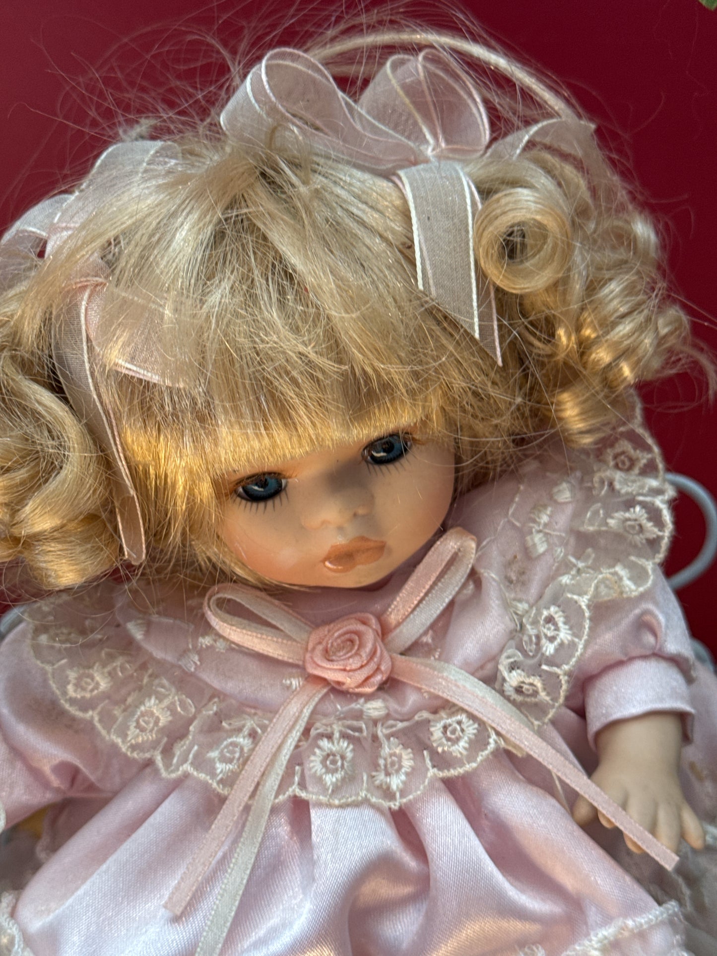 Vintage Porcelain Doll in Purple Dress on Floral Metal Swing