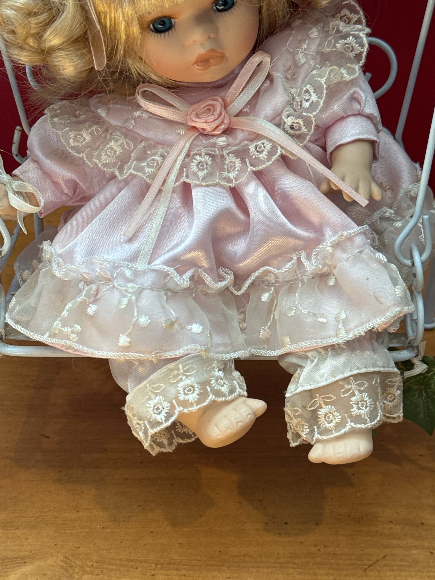 Vintage Porcelain Doll in Purple Dress on Floral Metal Swing